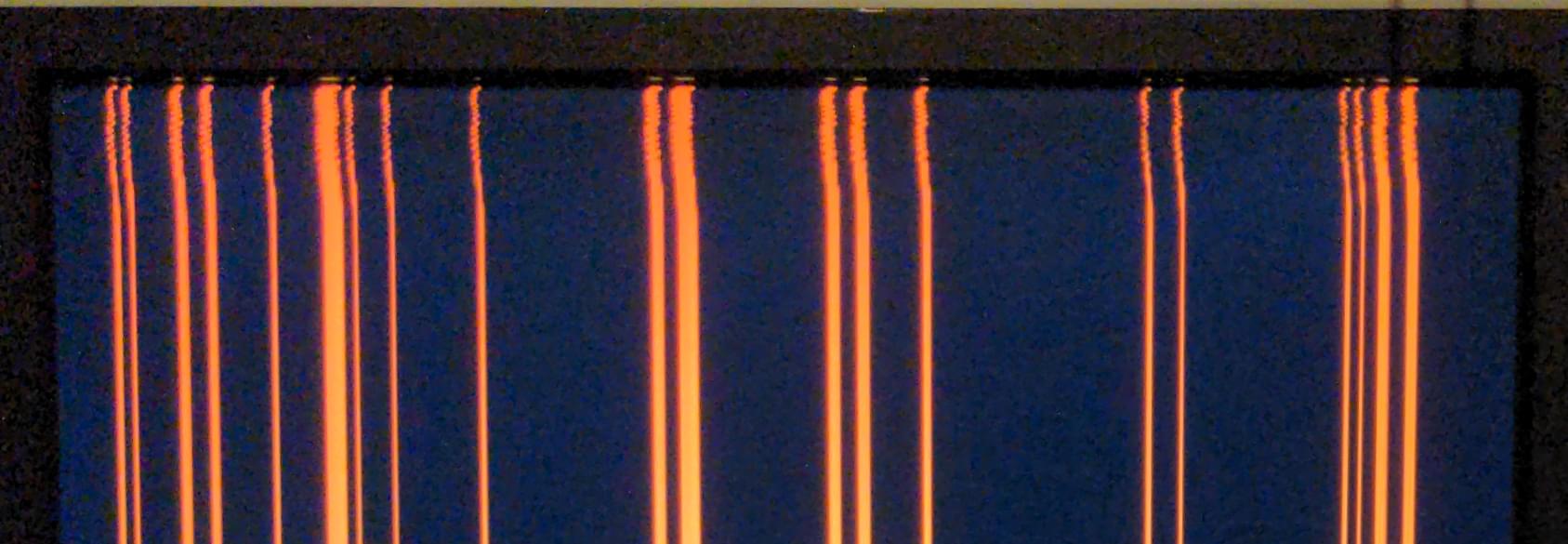 Amber vertical lines on a screen, but they're not straight at the top.